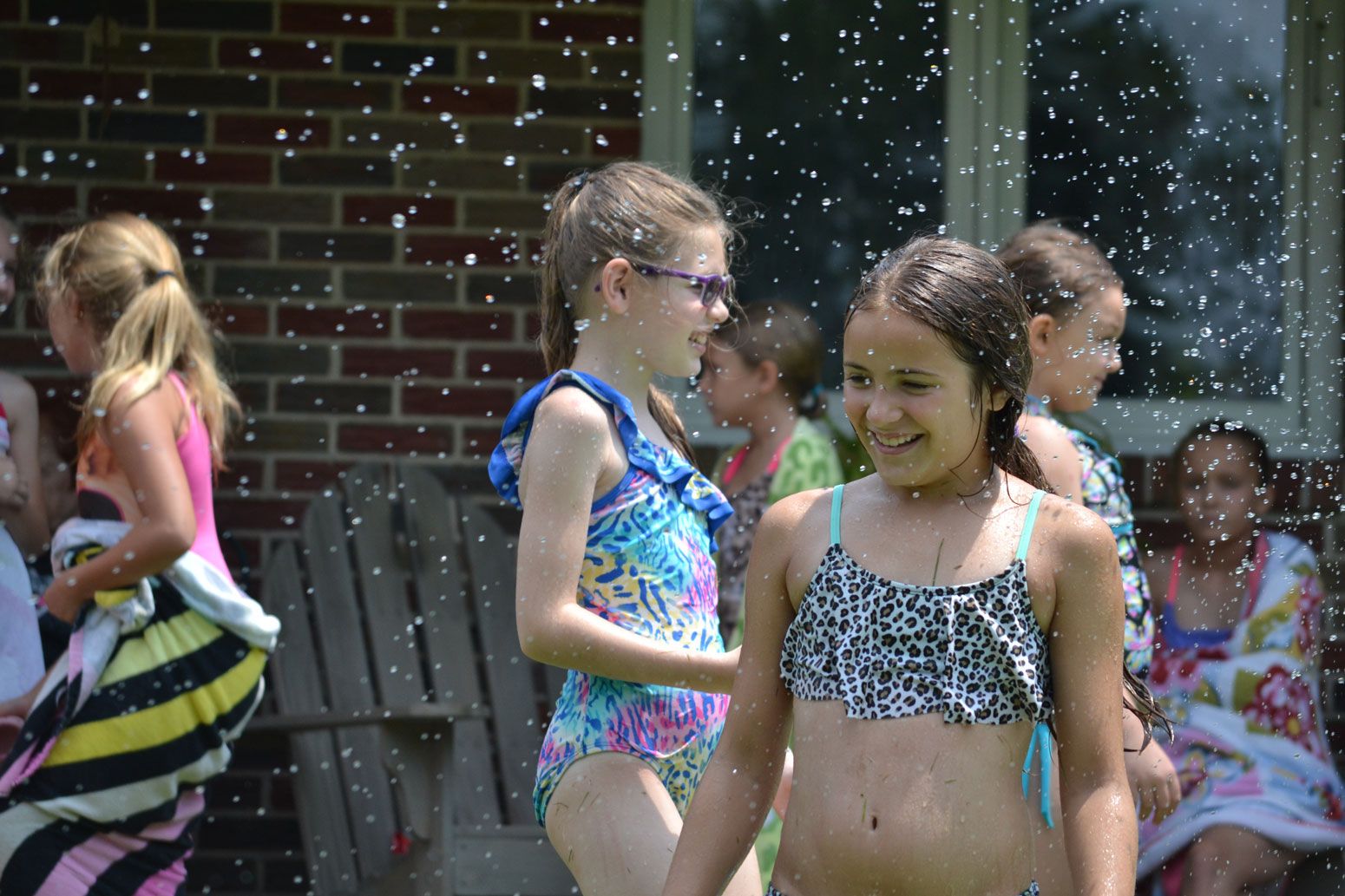 Kids hanging on a bar