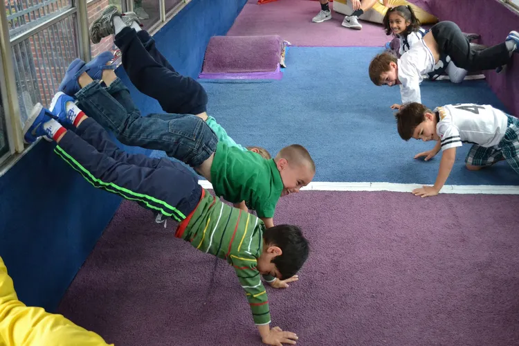 Boy hanging from bar