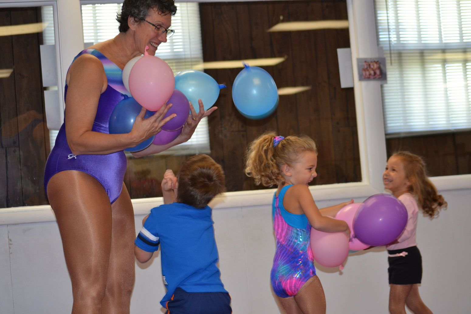 Kids hanging on a bar