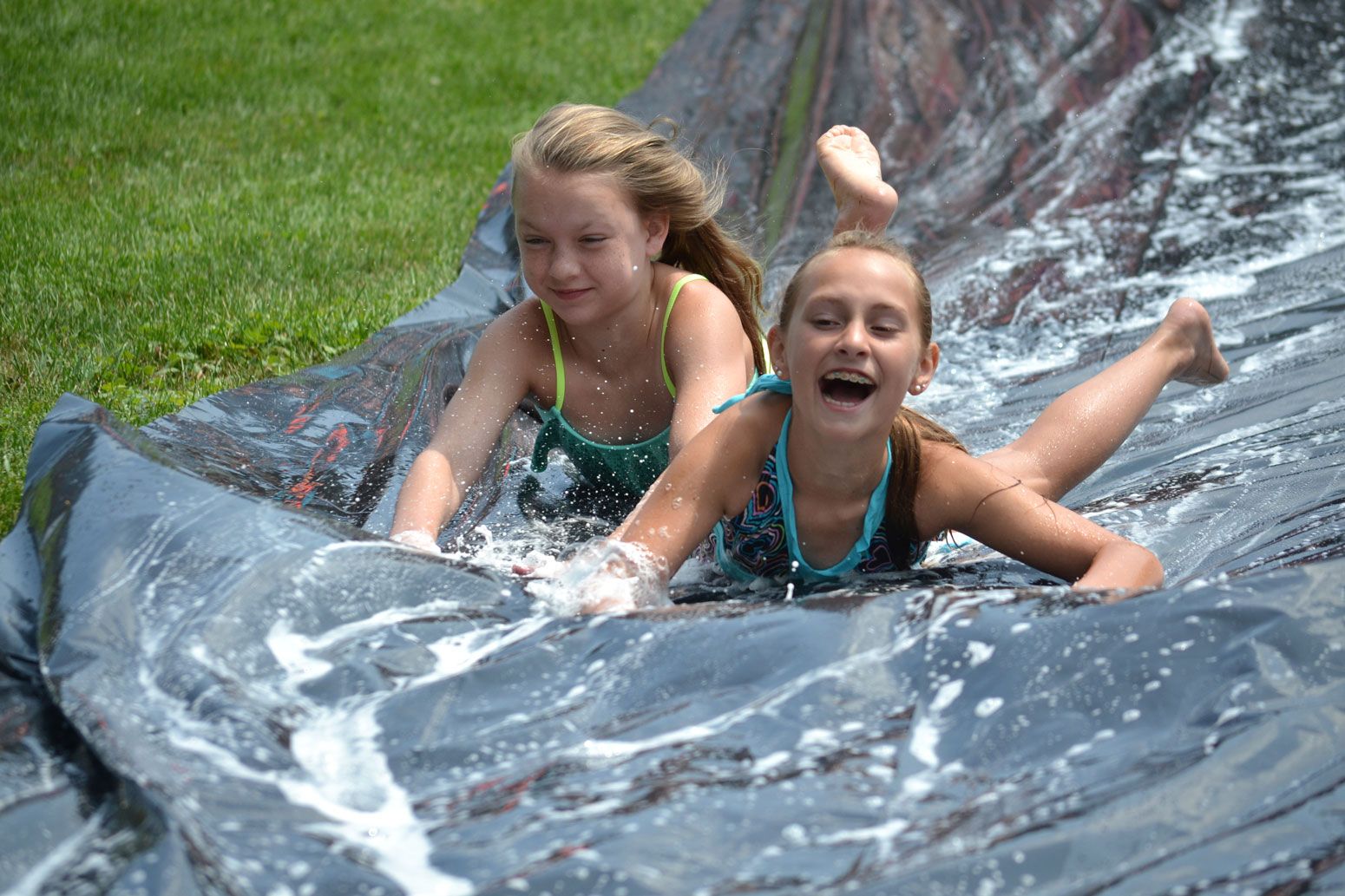 2 girls on a slip n' slide