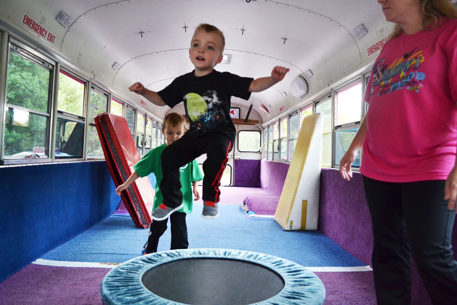 Boy hanging from bar